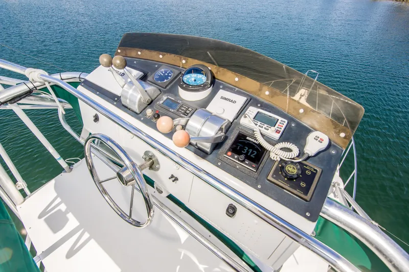 Slide: The Image of Helm of 1997 Cabo 35 Express boat with navigation instruments and steering wheel. - 11