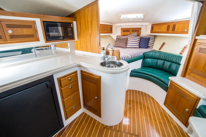 Slide: The Image of Interior of 1997 Cabo 35 Express yacht with kitchenette and seating area. - 19