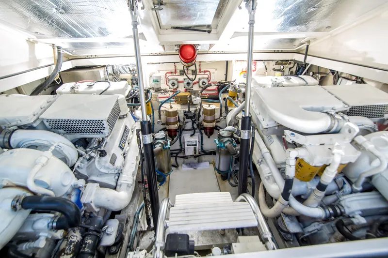 Slide: The Image of Engine room of a 1997 Cabo 35 Express boat, showcasing dual engines and mechanical components. - 26