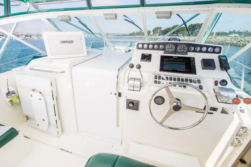 Slide: The Image of 1997 Cabo 35 Express boat helm with navigation equipment and steering wheel. - 6