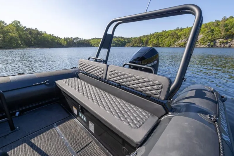 Slide: The Image of 2026 Highfield Patrol 700 boat on a serene lake. - 5