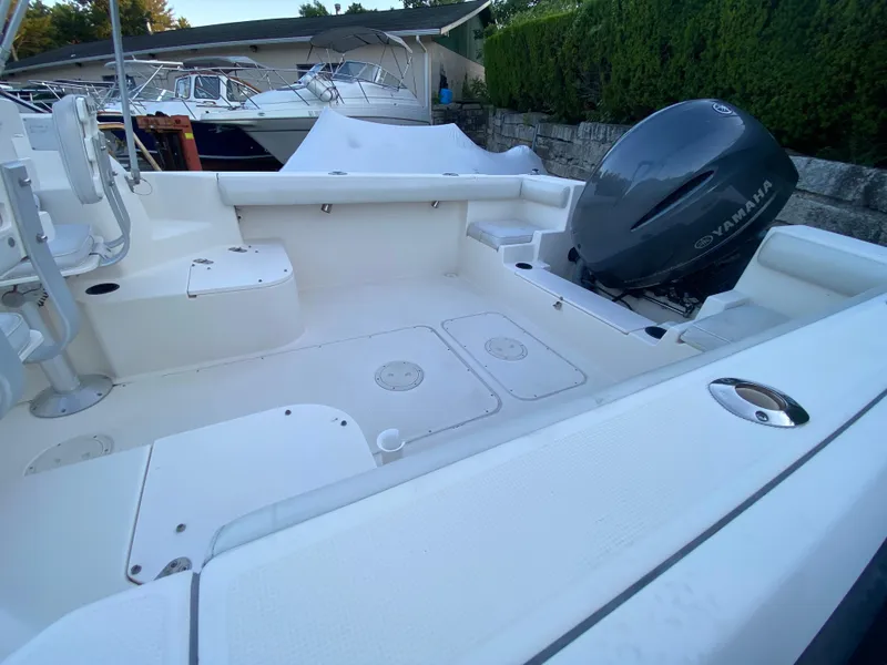 Slide: The Image of 1994 Pursuit 2150 boat with Yamaha outboard motor, spacious deck, and clean white finish. - 4