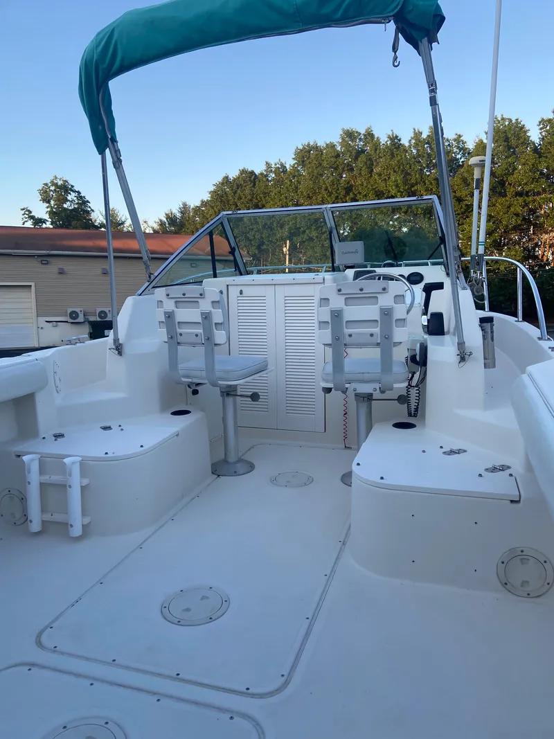 Slide: The Image of 1994 Pursuit 2150 boat interior with seating and canopy. - 7