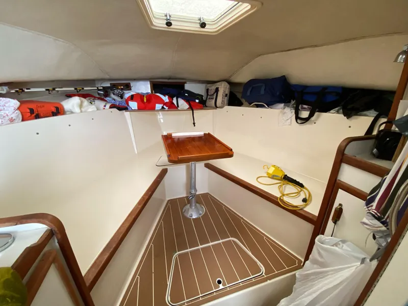 Slide: The Image of 1986 Blackfin 29 Combi cabin interior with storage and wooden table. - 10