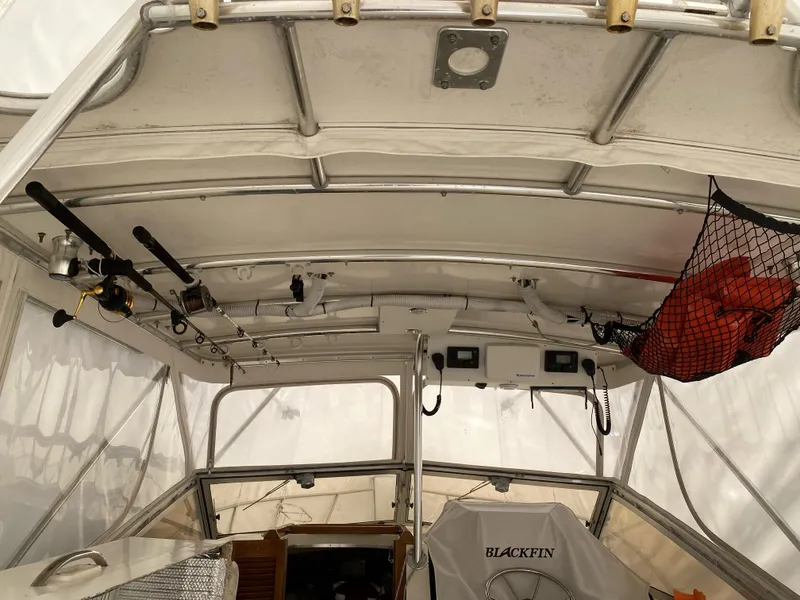 Slide: The Image of Interior view of 1986 Blackfin 29 Combi boat with fishing rods and equipment storage. - 3