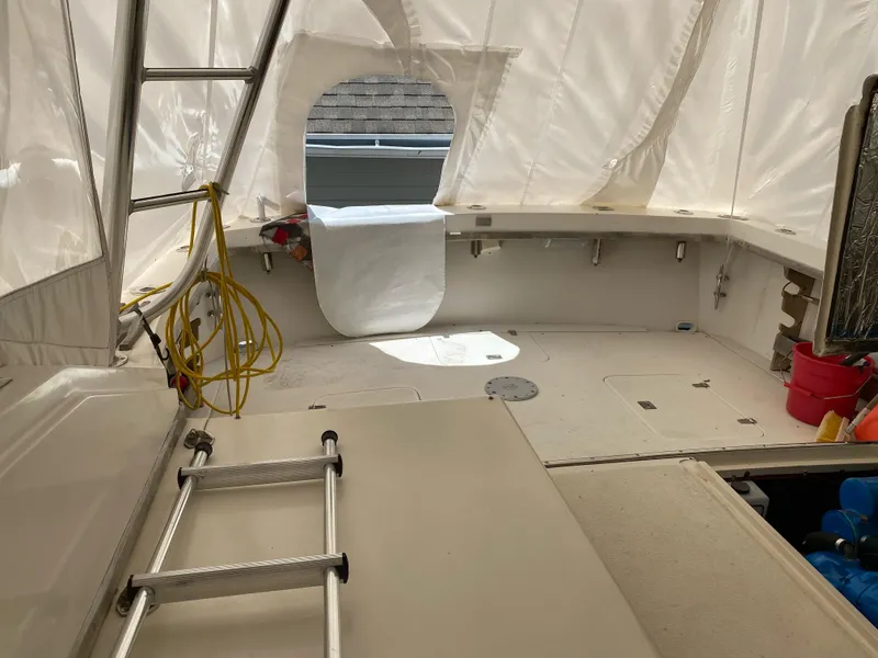 Slide: The Image of 1986 Blackfin 29 Combi boat interior with ladder and covered seating area. - 4