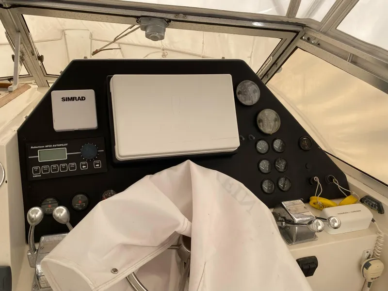 Slide: The Image of 1986 Blackfin 29 Combi boat dashboard with Simrad electronics and various gauges. - 7