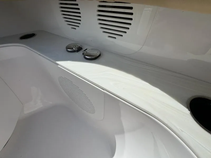 Slide: The Image of Phenom 34 boat interior detail, 2023 model, featuring sleek white design and ventilation grilles. - 13