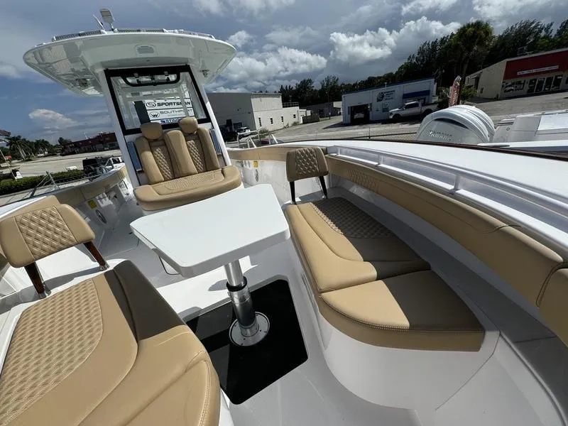 Slide: The Image of Luxurious 2023 Phenom 34 boat interior with beige seating and table. - 14