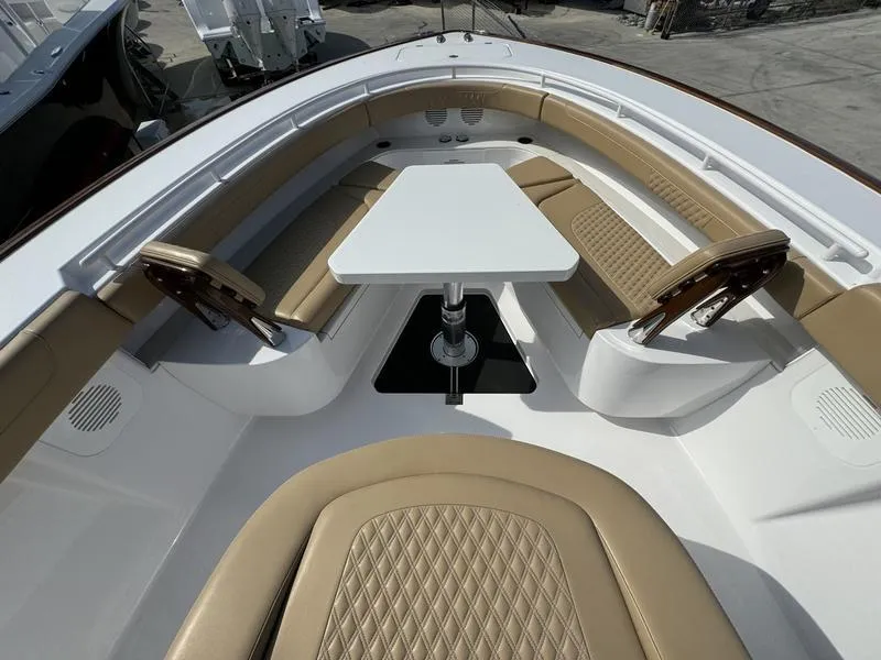 Slide: The Image of Phenom 34 boat interior, 2023 model, featuring tan leather seating and a central table. - 15