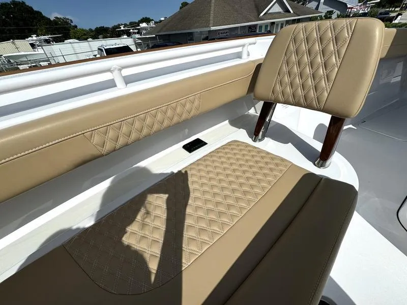 Slide: The Image of Luxurious tan seating on 2023 Phenom 34 boat with diamond stitching design. - 16