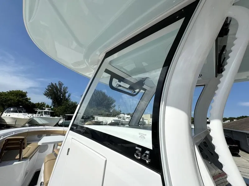 Slide: The Image of 2023 Phenom 34 boat, sleek design, modern cockpit, sunny day. - 24