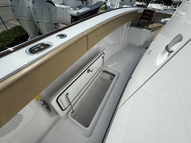 Slide: The Image of 2023 Phenom 34 boat interior with storage compartment and seating area. - 25