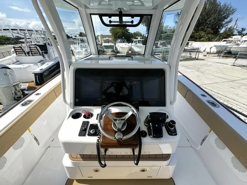 Slide: The Image of Phenom 34 boat cockpit, 2023 model, featuring modern steering and control panel. - 31