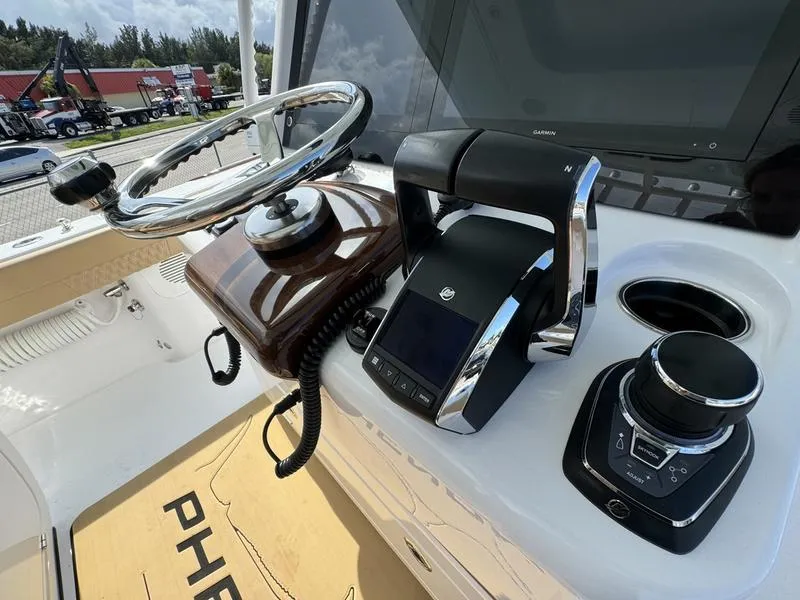 Slide: The Image of Phenom 34 boat helm with modern controls and steering wheel, 2023 model. - 32