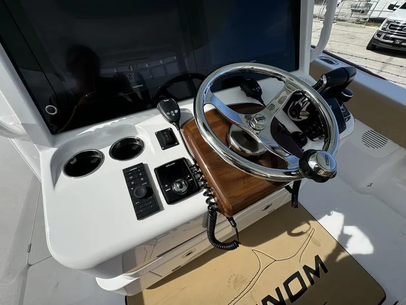 Slide: The Image of Phenom 34 boat helm with steering wheel and controls, 2023 model. - 33