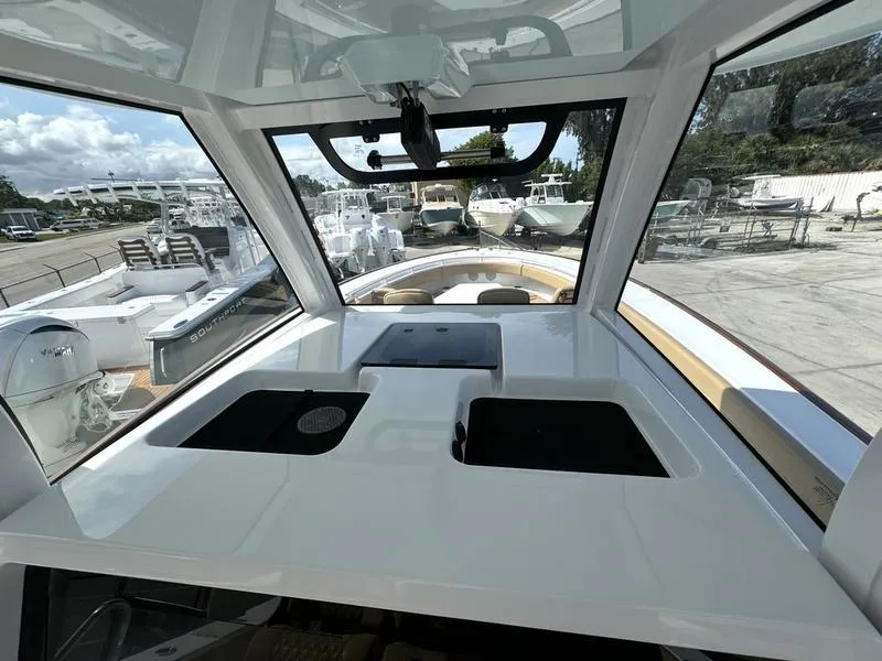 Slide: The Image of Interior view of 2023 Phenom 34 boat with modern dashboard and windows. - 35