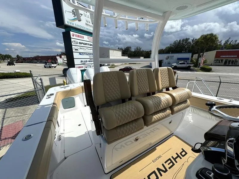 Slide: The Image of 2023 Phenom 34 boat interior with beige seating and steering console. - 37