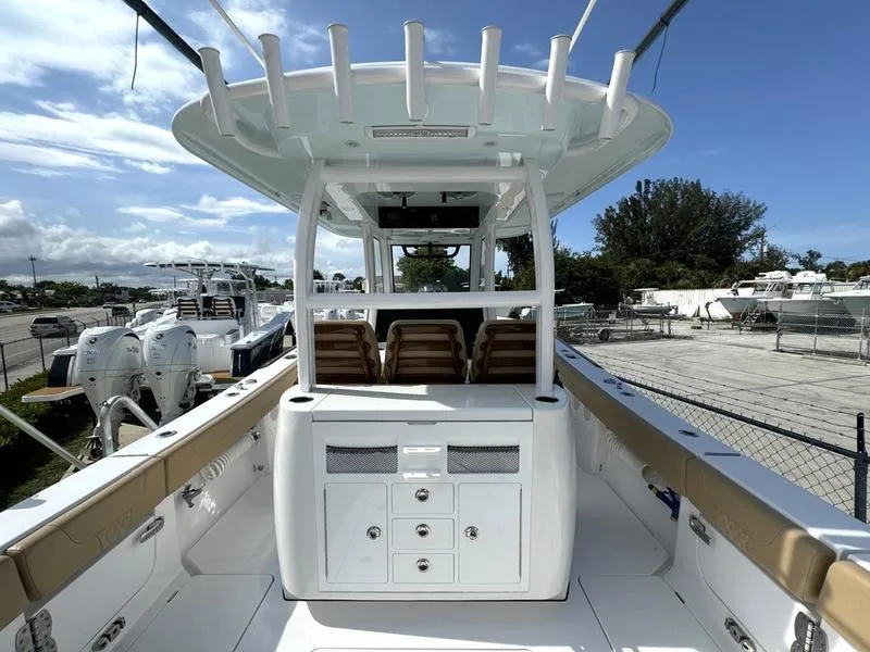 Slide: The Image of Phenom 34 boat interior, 2023 model, featuring seating and storage, docked outdoors. - 41