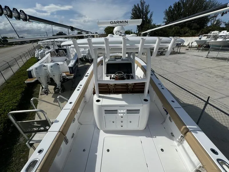 Slide: The Image of 2023 Phenom 34 boat with Garmin equipment, docked in a marina under a clear sky. - 42