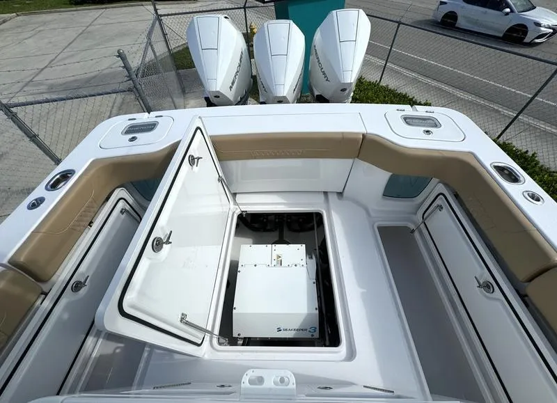 Slide: The Image of Phenom 34 boat, 2023 model, open storage compartment, triple outboard engines. - 48