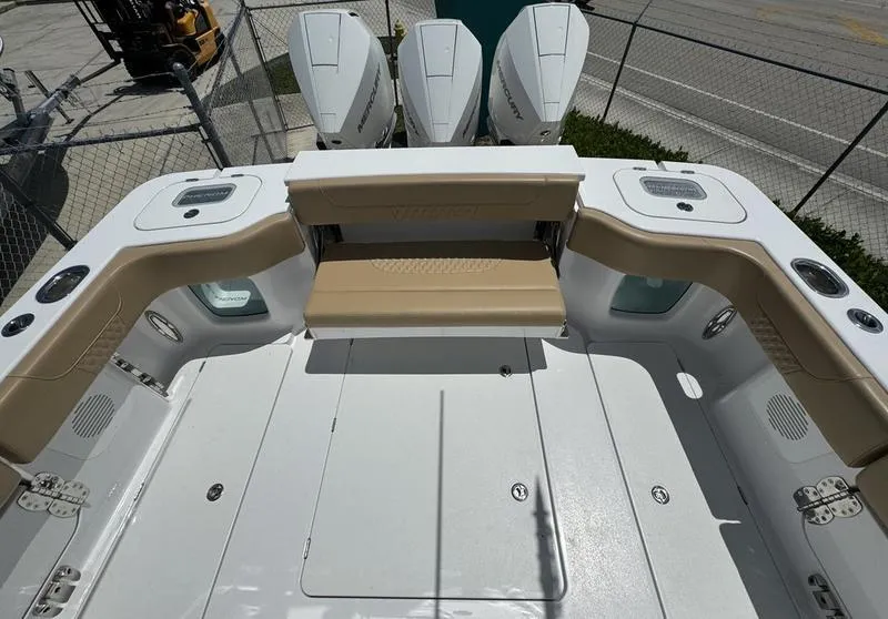 Slide: The Image of 2023 Phenom 34 boat deck with seating and triple outboard engines. - 49