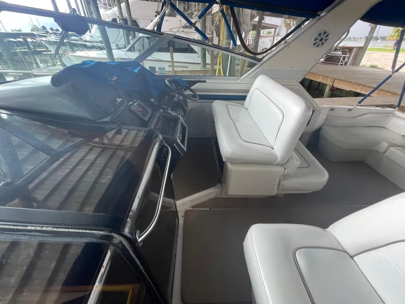 Slide: The Image of 1993 Sea Ray 400 Express Cruiser cockpit with white seating and control panel. - 11
