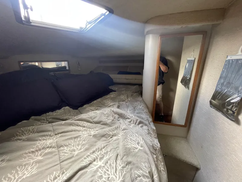 Slide: The Image of 1993 Sea Ray 400 Express Cruiser cabin with bed, mirror, and skylight. - 14
