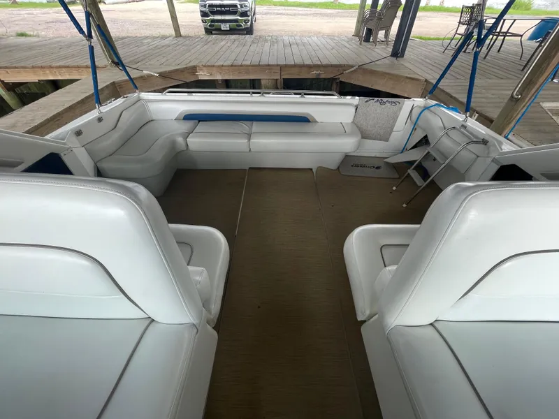 Slide: The Image of 1993 Sea Ray 400 Express Cruiser interior with white seating and spacious layout. - 23