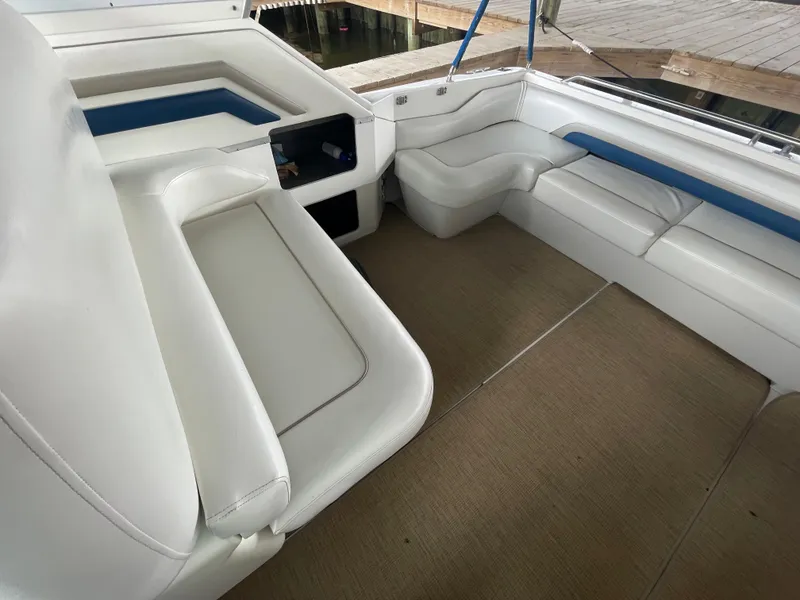 Slide: The Image of Interior seating area of a 1993 Sea Ray 400 Express Cruiser with white and blue upholstery. - 24