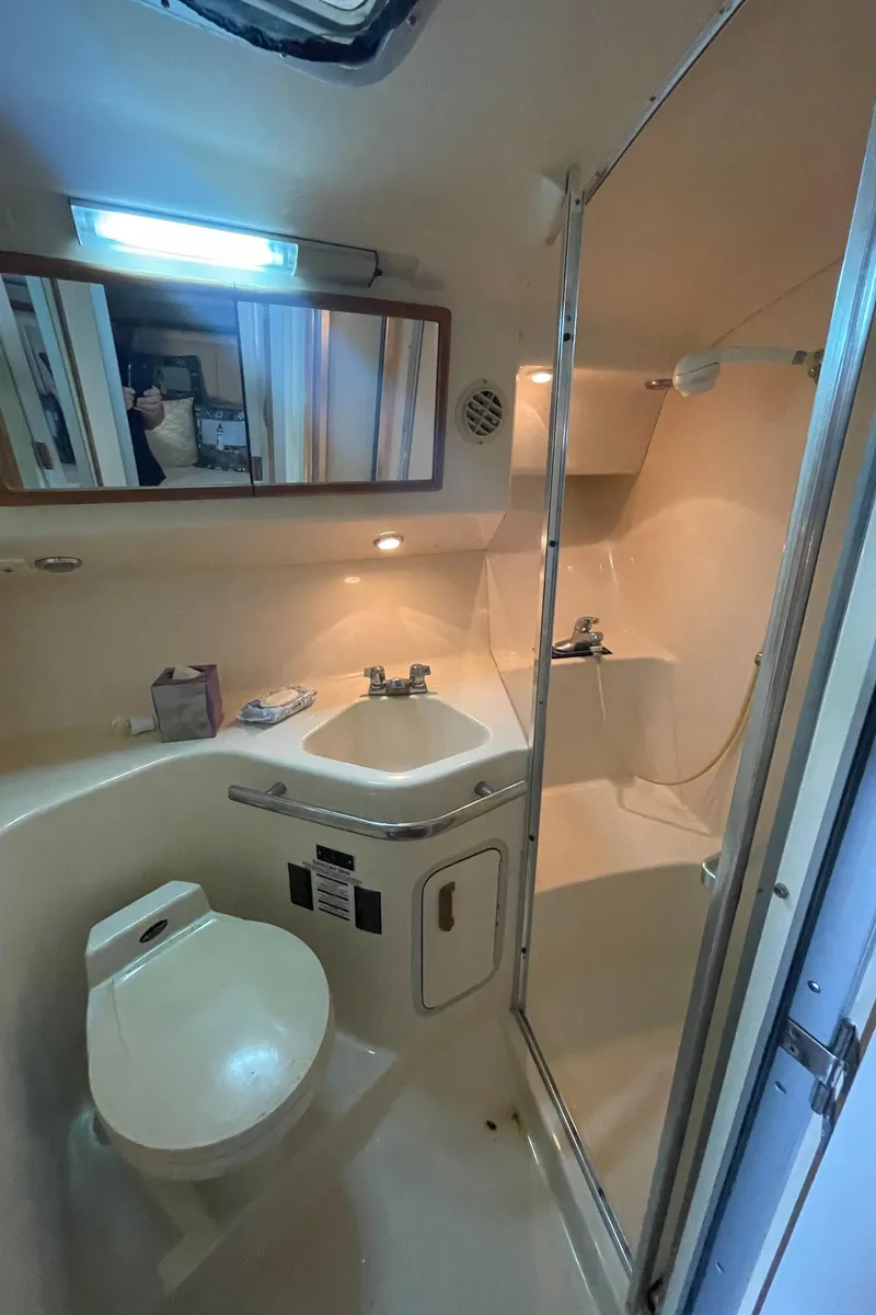 Slide: The Image of 1993 Sea Ray 400 Express Cruiser bathroom with shower, toilet, and sink. - 25