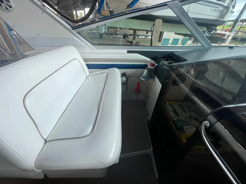 Slide: The Image of 1993 Sea Ray 400 Express Cruiser interior seating area with white upholstery. - 9