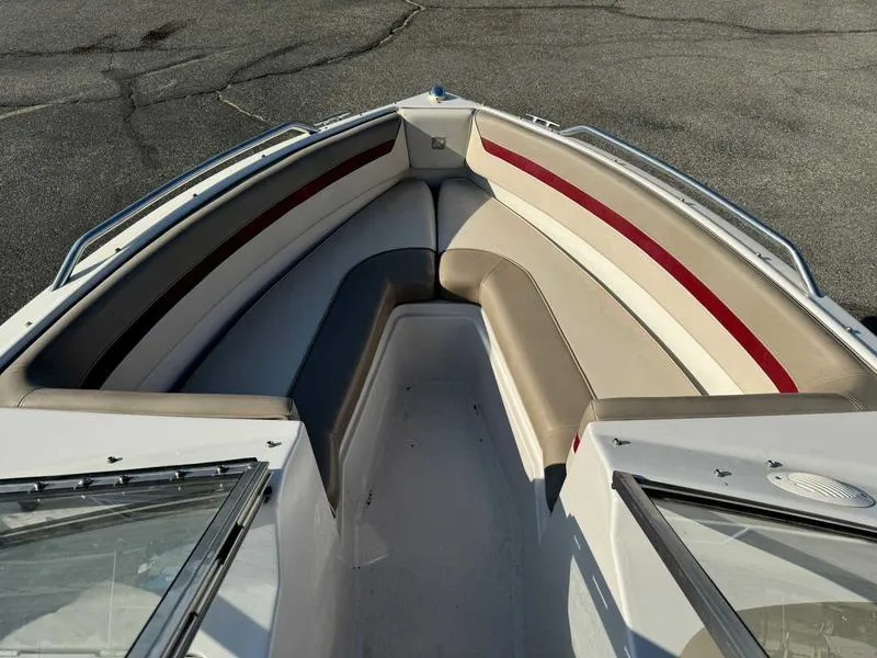 Slide: The Image of 1996 Four Winns 190 Horizon boat interior with cushioned seating. - 13