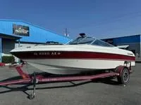 Slide: The Image of 1996 Four Winns 190 Horizon boat on a trailer outside a blue building. - 14