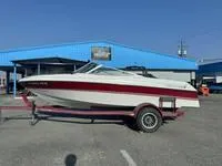 Slide: The Image of 1996 Four Winns 190 Horizon boat on a trailer in front of a blue building. - 15