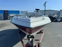 Slide: The Image of 1996 Four Winns 190 Horizon boat on a trailer in a parking lot. - 16