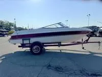 Slide: The Image of 1996 Four Winns 190 Horizon boat on trailer in parking lot. - 17