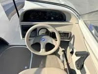 Slide: The Image of 1996 Four Winns 190 Horizon boat dashboard and steering wheel. - 23