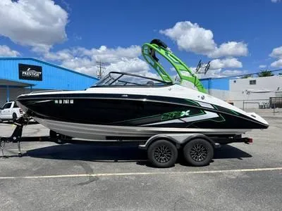Slide: The Image of 1996 Four Winns 190 Horizon boat on a trailer, parked outdoors. - 31