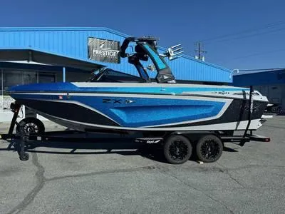 Slide: The Image of 1996 Four Winns 190 Horizon boat on trailer, blue and white, parked outside a blue building. - 34
