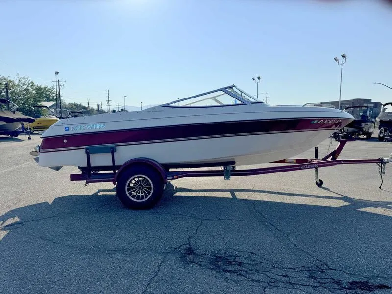 Slide: The Image of 1996 Four Winns 190 Horizon boat on a trailer in a parking lot. - 5