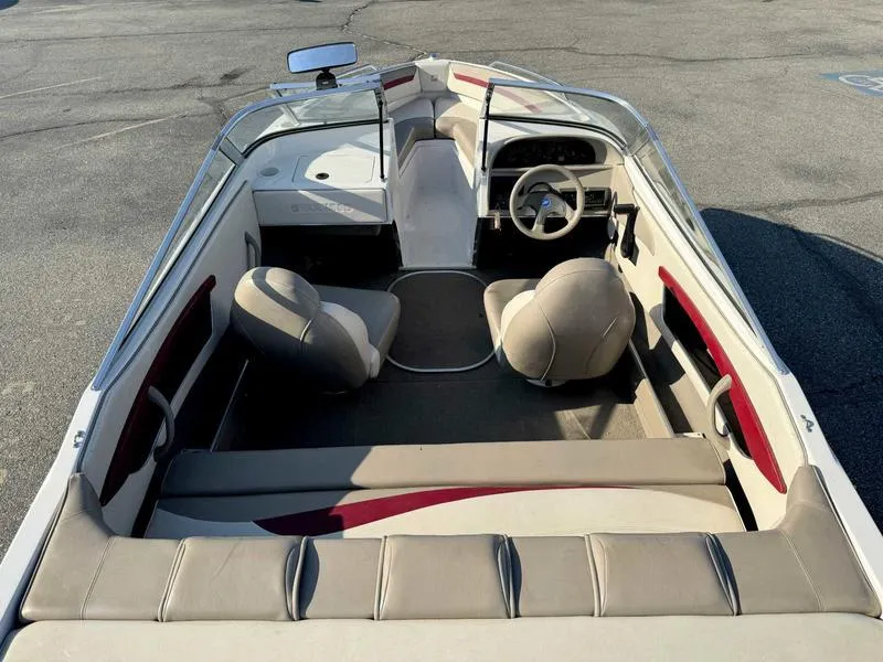 Slide: The Image of 1996 Four Winns 190 Horizon boat interior with seating and steering wheel. - 8