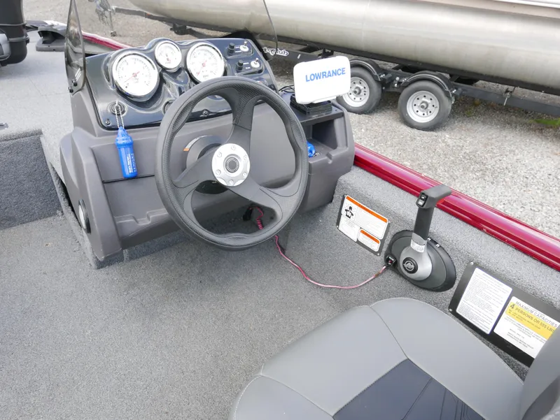 Slide: The Image of 2022 Tracker Pro 170 boat dashboard with steering wheel and Lowrance fish finder. - 14