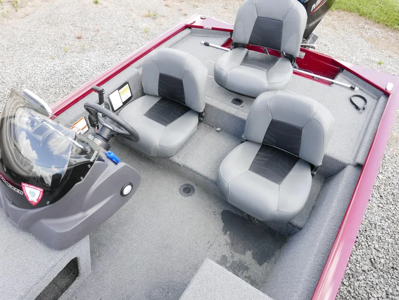 Slide: The Image of 2022 Tracker Pro 170 boat interior with three gray seats and steering console. - 8