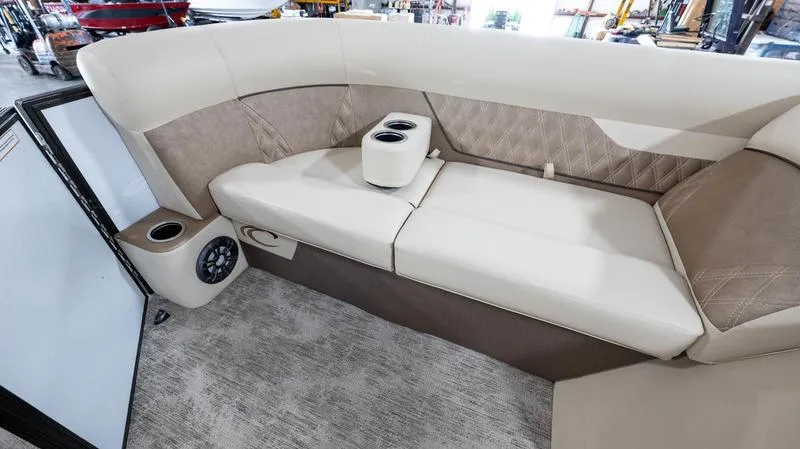 Slide: The Image of 2021 Crest Classic Platinum 220 SLSC boat interior with beige seating and cup holders. - 10