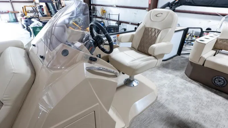 Slide: The Image of 2021 Crest Classic Platinum 220 SLSC boat interior with captain's chair and steering console. - 13