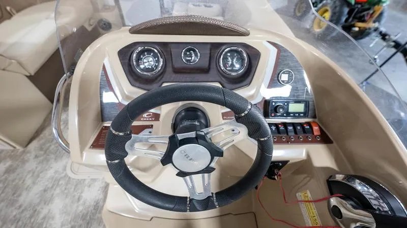Slide: The Image of 2021 Crest Classic Platinum 220 SLSC boat dashboard with steering wheel and control panel. - 17