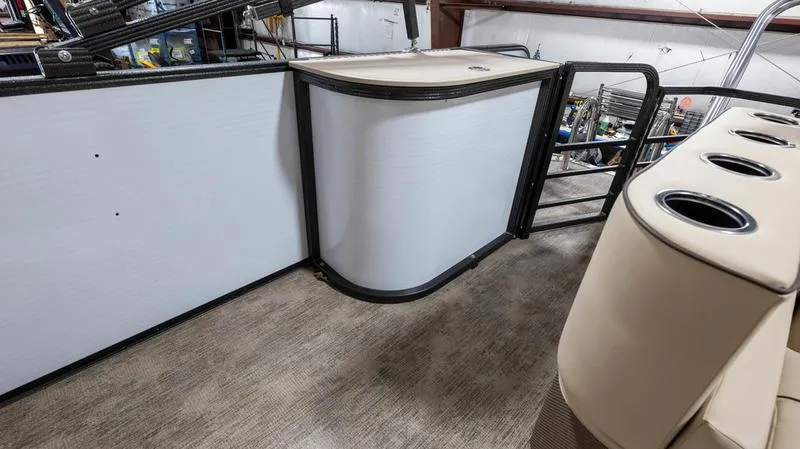 Slide: The Image of 2021 Crest Classic Platinum 220 SLSC boat interior with beige seating and cup holders. - 22