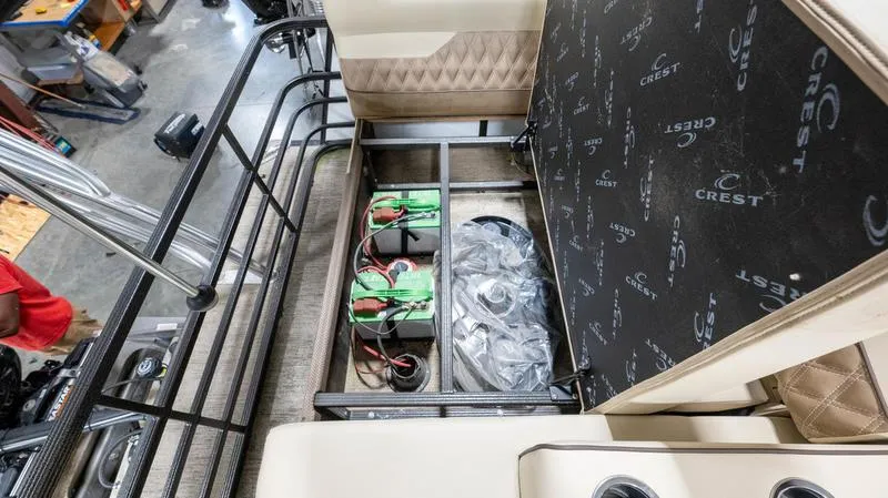 Slide: The Image of 2021 Crest Classic Platinum 220 SLSC boat interior storage compartment with batteries. - 24