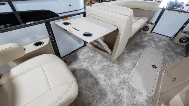 Slide: The Image of 2021 Crest Classic Platinum 220 SLSC interior with beige seating and foldable table. - 27